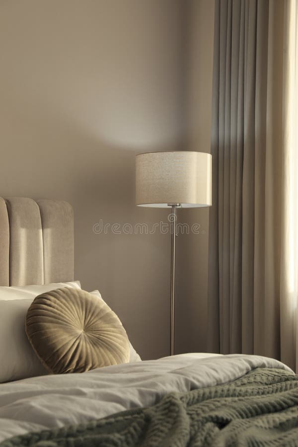 Stylish Floor Lamp Near Bed in Room. Interior Element Stock Photo