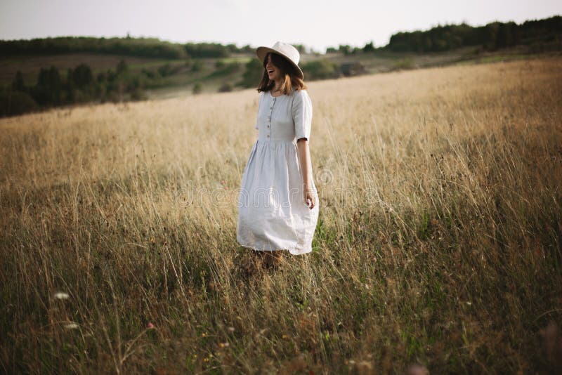 Stylish Girl in Linen Dress Walking among Herbs and Wildflowers in ...