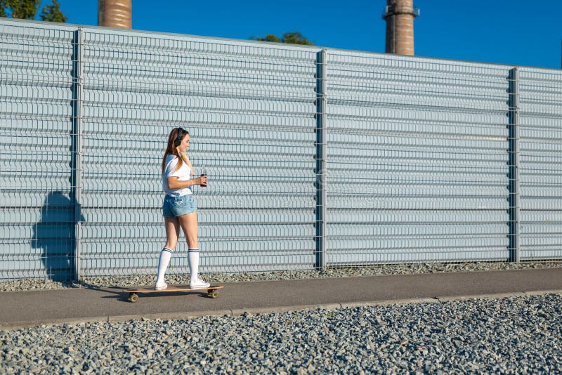 Beautiful sexy young girl in short shorts walking with longboard – ITC  SHOPPING FESTIVAL