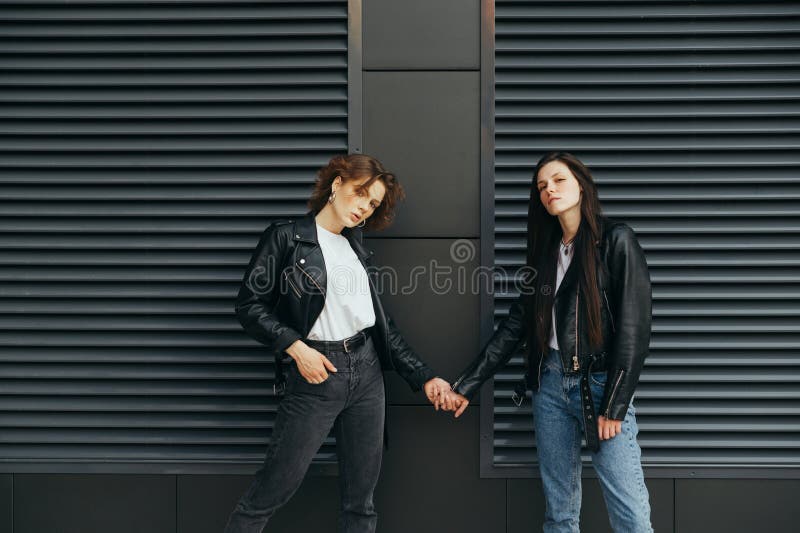 Two beautiful girls in casual clothes posing outdoor Stock Photo