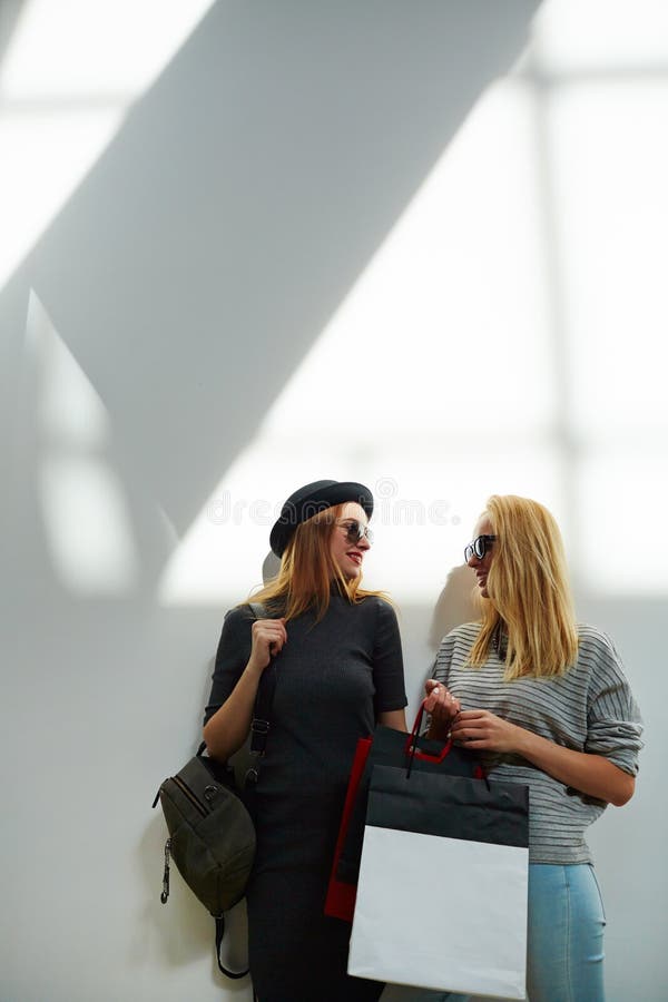 Stylish girls on wall background stock image Stylish girls on wall background stock image