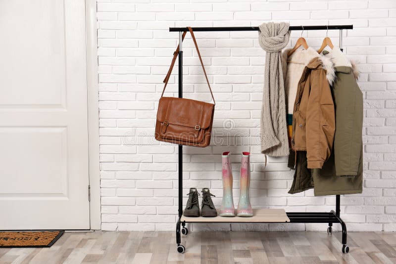 Stylish Hallway Interior with Shoes and Clothes on Hanger Stock Photo