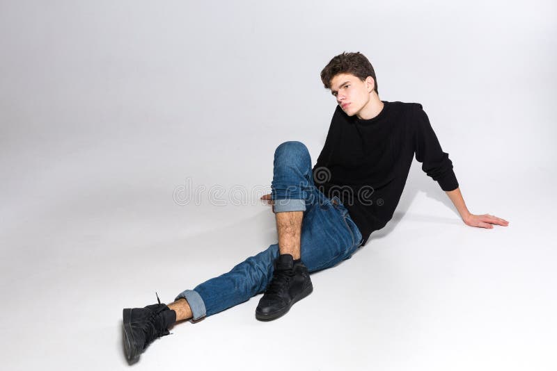 Sexy Handsome Man Sitting In Lotus Pose Wearing Casual Jeans And Unbuttoned  Shirt Stock Photo, Picture and Royalty Free Image. Image 15389617.