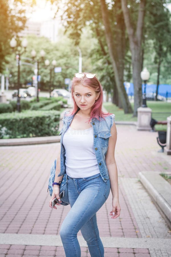 Stylish hipster girl in denim clothes on a city street royalty free stock photography Stylish hipster girl in denim clothes on a city street royalty free stock photography