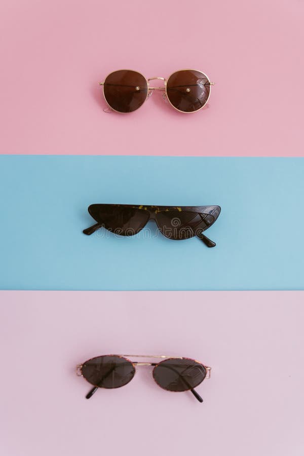 Stylish image sunglasses on a pastel background. Three pairs of glasses with lenses on a pink and blue backgrounds