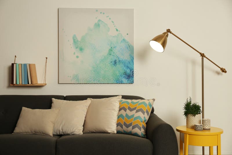 Stylish Living Room Interior with Comfortable Sofa and Lamp Stock Image