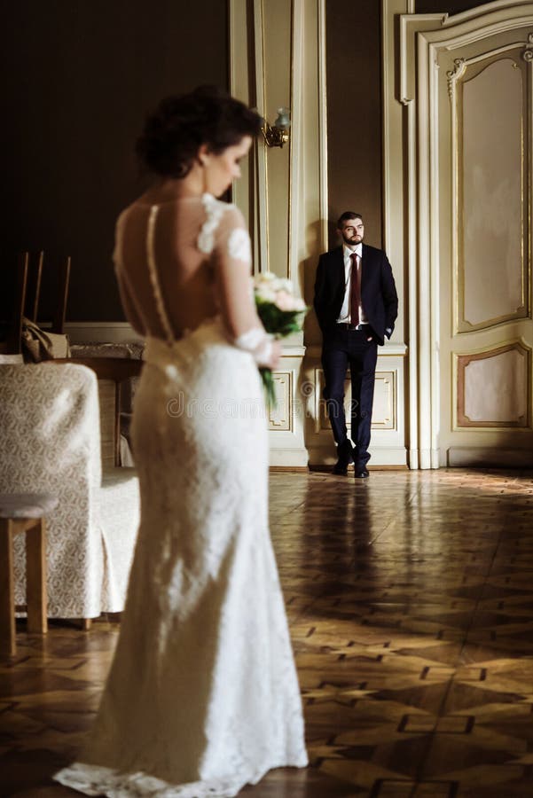 Stylish luxury bride and handsome elegant groom posing on the ba stock photos