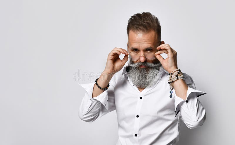 Stylish man with beard looks over glasses