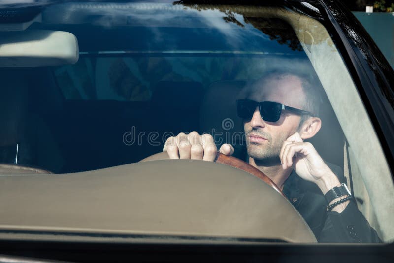Stylish man in suit in black car. Business Man in glasses sitting in luxury auto. Success people. Millionaire gangster stock photos Stylish man in suit in black car. Business Man in glasses sitting in luxury auto. Success people. Millionaire gangster stock photos