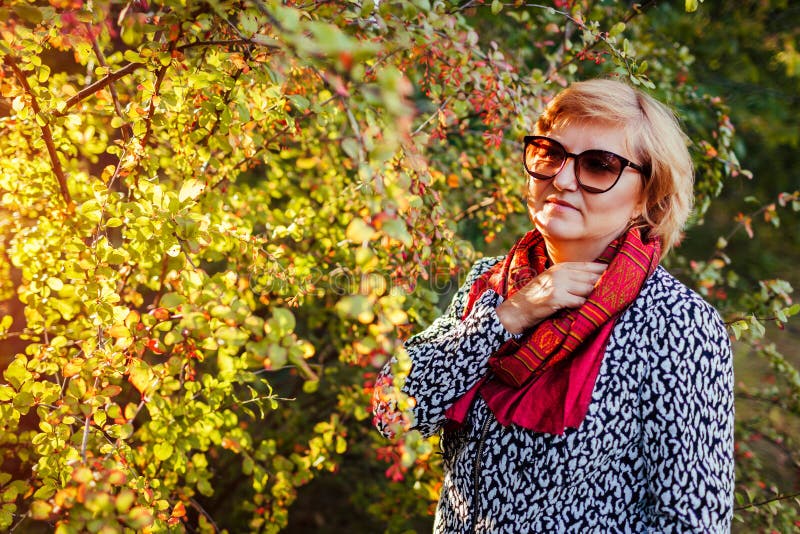 Stylish Middle-aged Woman Posing in Autumn Forest. Senior Lady Wearing ...