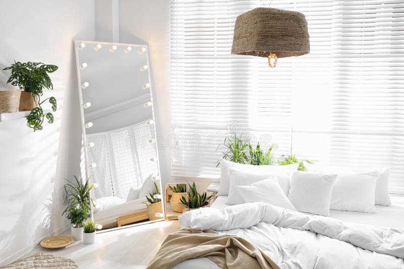 Stylish Mirror with Light Bulbs in Bedroom. Interior Design Stock Photo