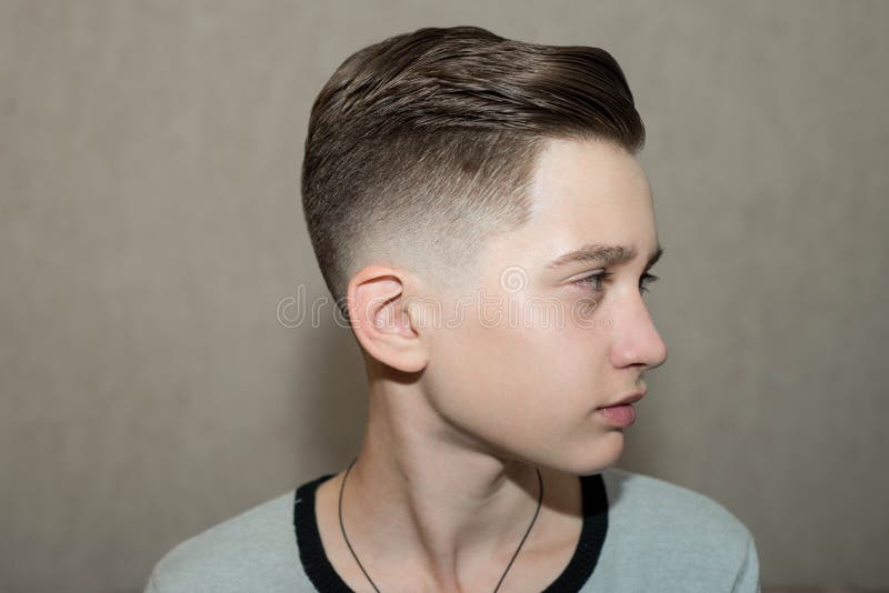 Stylish Modern Retro Haircut Side Part with Mid Fade with Parting of a  School Boy Guy in a Barbershop on a Brown Background Stock Photo - Image of  hair, european: 161348390