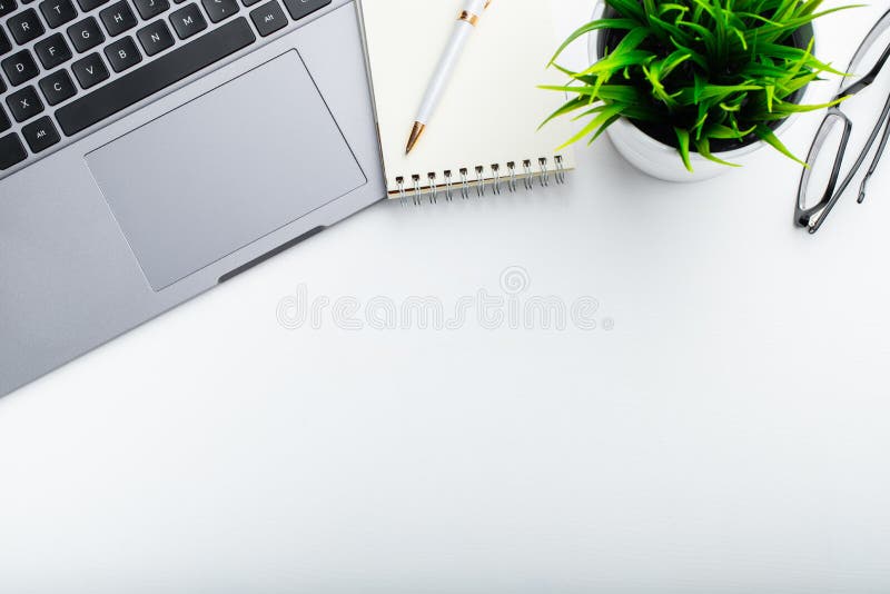 Stylish office table desk. Workspace with laptop, diary, succulent on white background. Flat lay, top view with copy space for tex