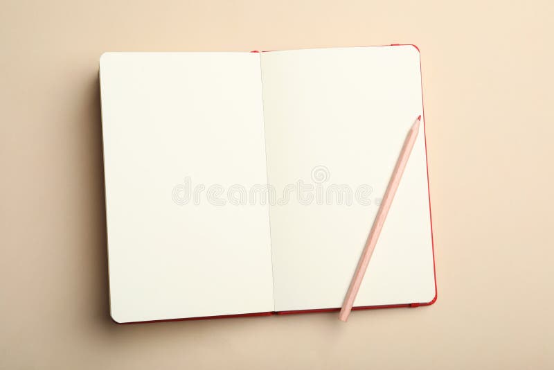 Stylish open notebook and pencil on beige, top view stock photos