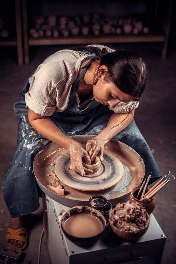 Stylish Pottery Woman Siting on Bench with Pottery Wheel and Making Clay  Pot. National Craft. Stock Photo - Image of handicrft, shape: 147147962