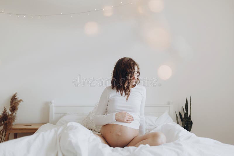 Stylish pregnant mom hugging belly with love and care, waiting for baby. Motherhood concept, magic time. Happy pregnant woman in royalty free stock photos Stylish pregnant mom hugging belly with love and care, waiting for baby. Motherhood concept, magic time. Happy pregnant woman in royalty free stock photos