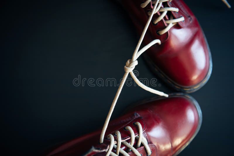 Stylish Red Shoes with Laces Linked Together on Black Background. High ...