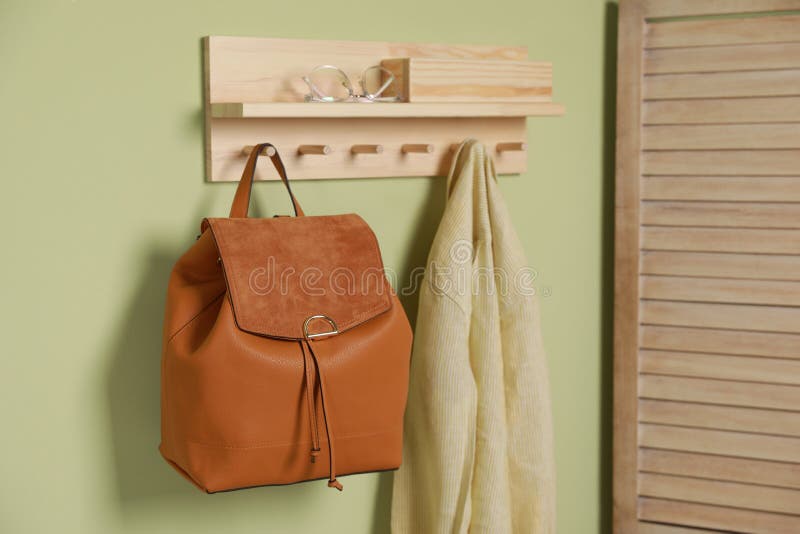 Stylish Urban Backpack and Jacket on Hanger Indoors Stock Photo Image