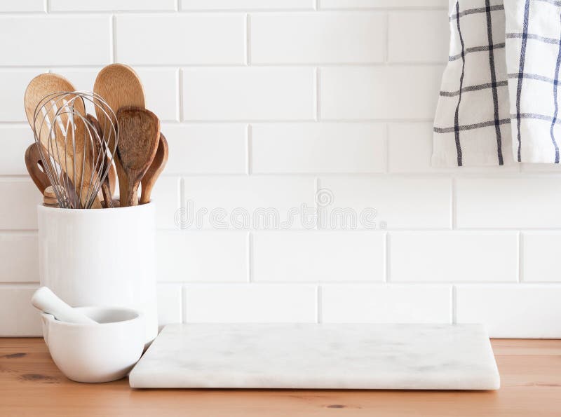 Kitchen with white stone countertops, solid wood cabinets, and vintage tile  on the walls Stock Photo - Alamy