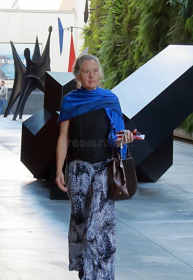 A stylish woman with blue scarf in San Francisco, California.