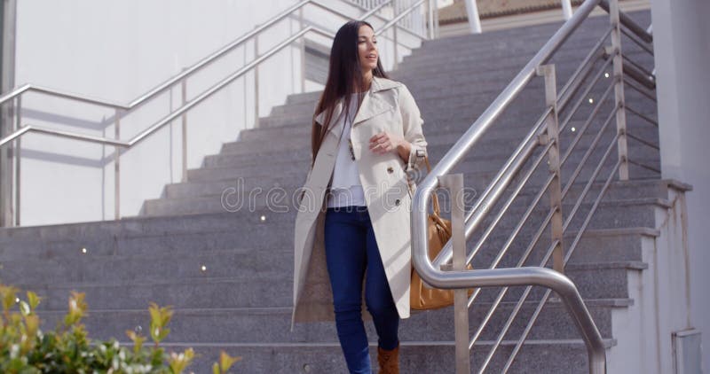 Stylish woman walking down a flight of stairs