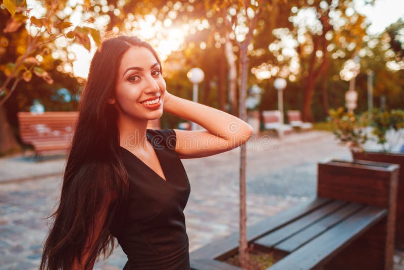 Stylish young business woman chilling in summer park. Fashionable outfit. Happy beautiful model smiling at camera stock images Stylish young business woman chilling in summer park. Fashionable outfit. Happy beautiful model smiling at camera stock images