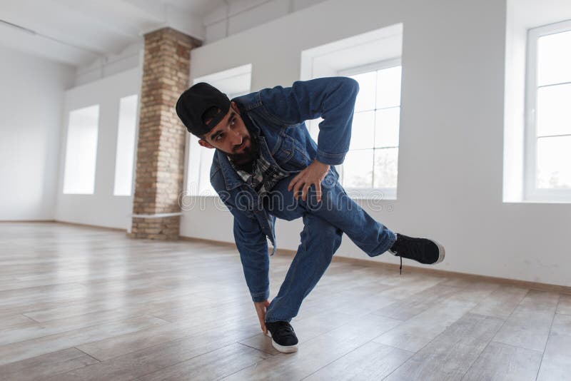 Man Dancer in Jeans Clothes Dancing Breakdance in Dance Studio. Stock