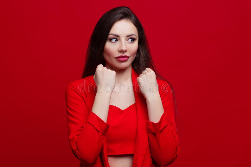 Stylish Young Woman in a Red Suit on a Red Background. Stock Photo ...