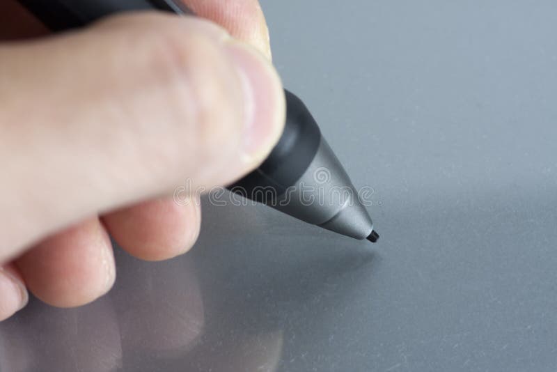 Close of fingers holding a stylus digitizer pen ready to draw. Close of fingers holding a stylus digitizer pen ready to draw