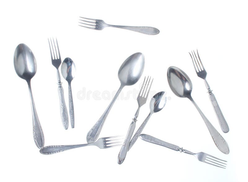 Set of old retro forks and spoons isolated on white background. Top view. Set of old retro forks and spoons isolated on white background. Top view