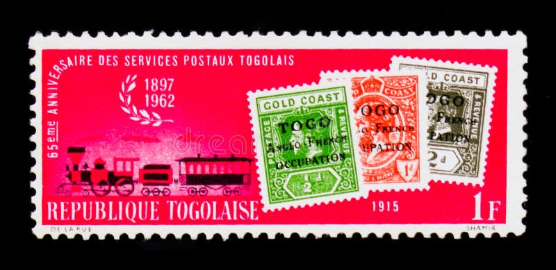 MOSCOW, RUSSIA - SEPTEMBER 3, 2017: A stamp printed in Togolese Republic shows stamps of 1915 and steam mail train, 65th Anniversary of Togolese Postal Services serie, circa 1962. MOSCOW, RUSSIA - SEPTEMBER 3, 2017: A stamp printed in Togolese Republic shows stamps of 1915 and steam mail train, 65th Anniversary of Togolese Postal Services serie, circa 1962