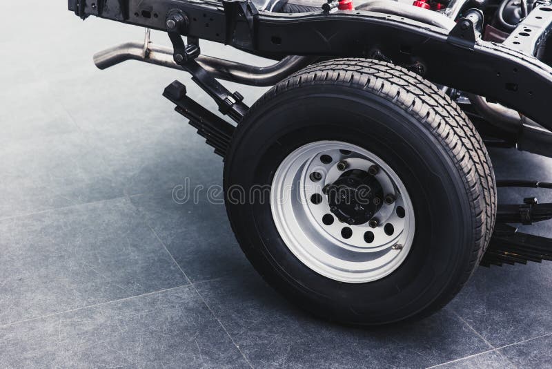 Close up pickup truck rear tire with car chassis underbody clean new from factory. Close up pickup truck rear tire with car chassis underbody clean new from factory