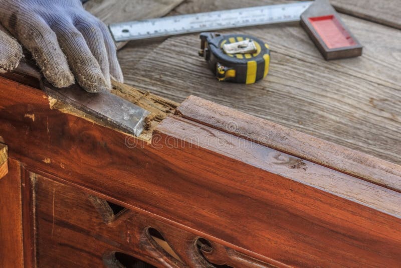 Close up the chisel to sharpen the wood plank. Close up the chisel to sharpen the wood plank