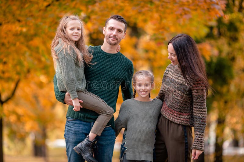 Stående av den lyckliga familjen av fyra i höstdag royaltyfri foto Stående av den lyckliga familjen av fyra i höstdag royaltyfri foto