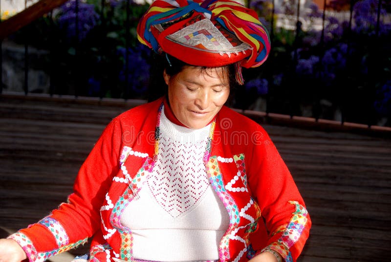 AREQUIPA PERU NOVEMBER 27:Portrait of peruvian Indian Woman in Traditional Dress Weaving alpaca wool on november 27 2010 in Arequipa Peru. The national poverty rate is over 50 per cent. AREQUIPA PERU NOVEMBER 27:Portrait of peruvian Indian Woman in Traditional Dress Weaving alpaca wool on november 27 2010 in Arequipa Peru. The national poverty rate is over 50 per cent.