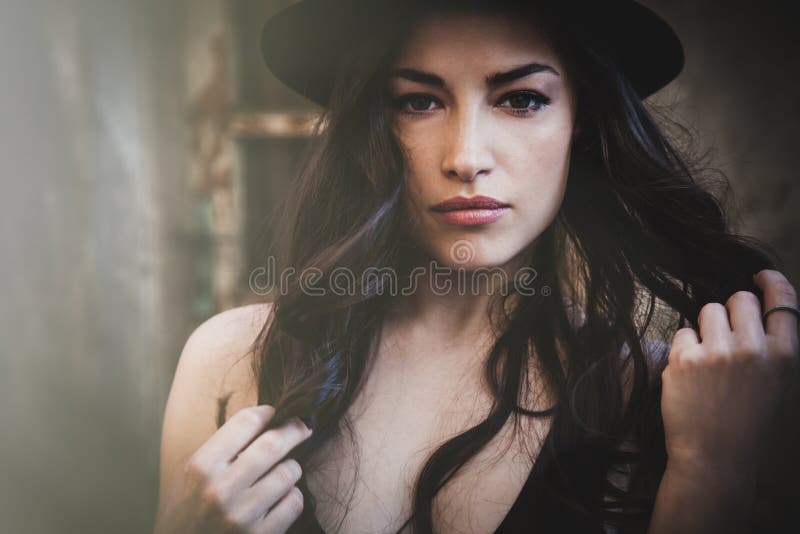 Portrait of young woman with hat outdoor in the city summer day natural light front view. Portrait of young woman with hat outdoor in the city summer day natural light front view