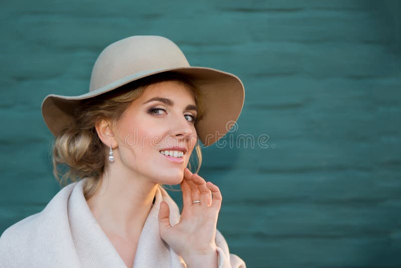 Portrait of a beautiful woman in a hat and coat outdoor . retro wedding style 50-ies. toned photo. Portrait of a beautiful woman in a hat and coat outdoor . retro wedding style 50-ies. toned photo.