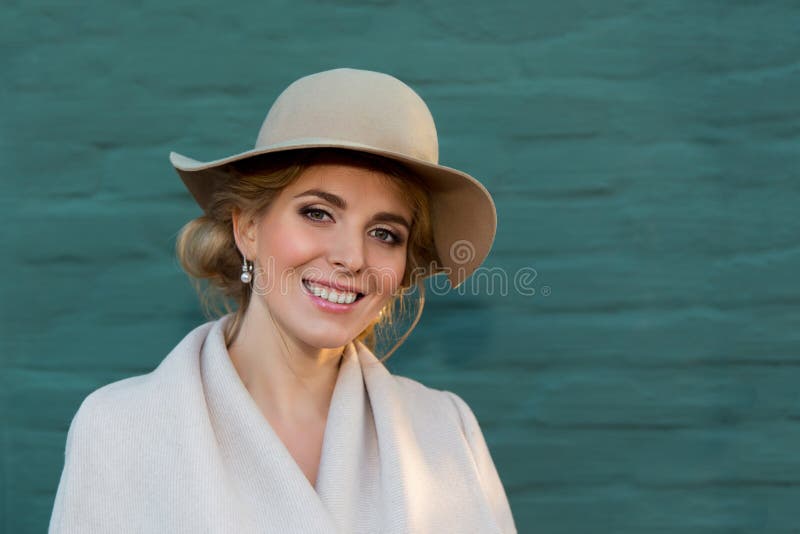 Portrait of a beautiful woman in a hat and coat outdoor . retro wedding style 50-ies. toned photo. Portrait of a beautiful woman in a hat and coat outdoor . retro wedding style 50-ies. toned photo.