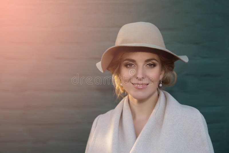 Portrait of a beautiful woman in a hat and coat outdoor . retro wedding style 50-ies. toned photo. Portrait of a beautiful woman in a hat and coat outdoor . retro wedding style 50-ies. toned photo.