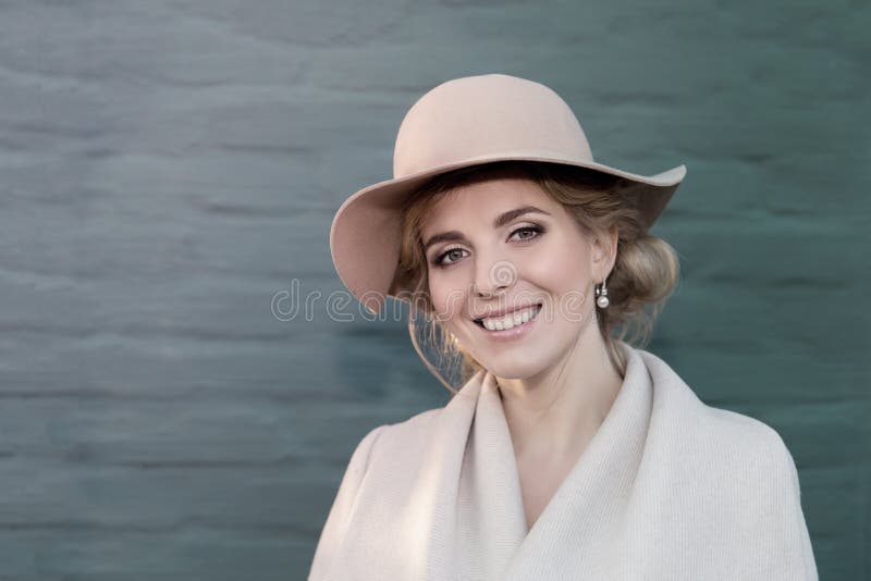 Portrait of a beautiful woman in a hat and coat outdoor . retro wedding style 50-ies. toned photo. Portrait of a beautiful woman in a hat and coat outdoor . retro wedding style 50-ies. toned photo.