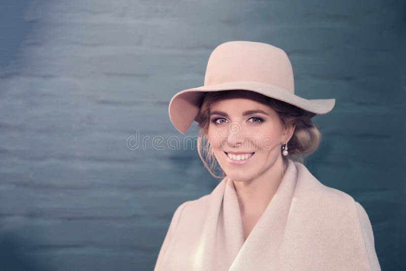 Portrait of a beautiful woman in a hat and coat outdoor . retro wedding style 50-ies. toned photo. Portrait of a beautiful woman in a hat and coat outdoor . retro wedding style 50-ies. toned photo.