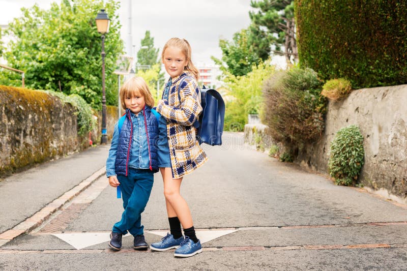 Cute kids with backpacks walking to school. Cute kids with backpacks walking to school