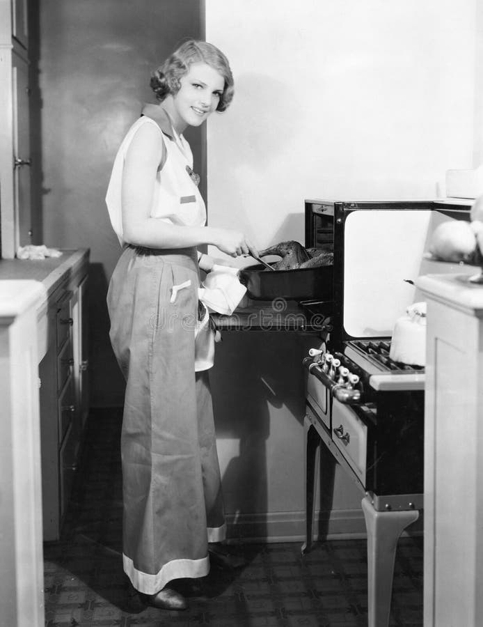 Portrait of woman cooking (All persons depicted are no longer living and no estate exists. Supplier grants that there will be no model release issues.). Portrait of woman cooking (All persons depicted are no longer living and no estate exists. Supplier grants that there will be no model release issues.)