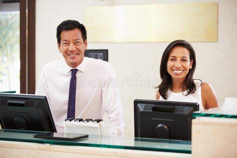 Stående av mottagandepersonalen på hotellet Front Desk fotografering för bildbyråer Stående av mottagandepersonalen på hotellet Front Desk fotografering för bildbyråer