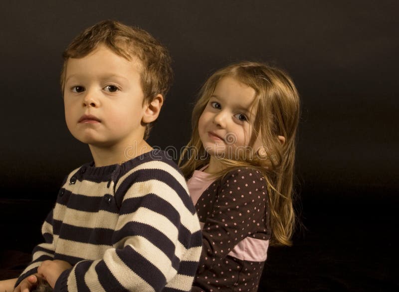 Portrait of fraternal twins in a studio setting. Portrait of fraternal twins in a studio setting.