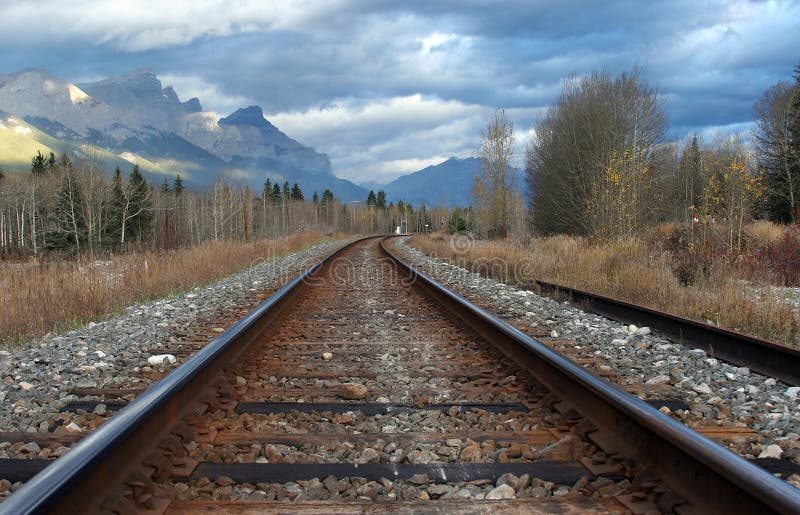 A set of railway tracks heading into the mountains. A set of railway tracks heading into the mountains