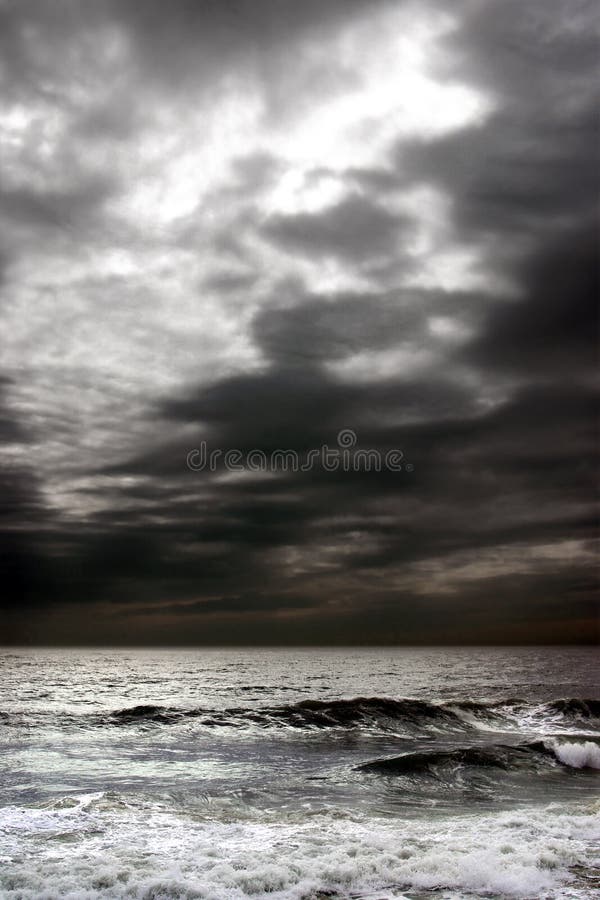 Stormy dark clouds in the sky over troubled ocean. Stormy dark clouds in the sky over troubled ocean.