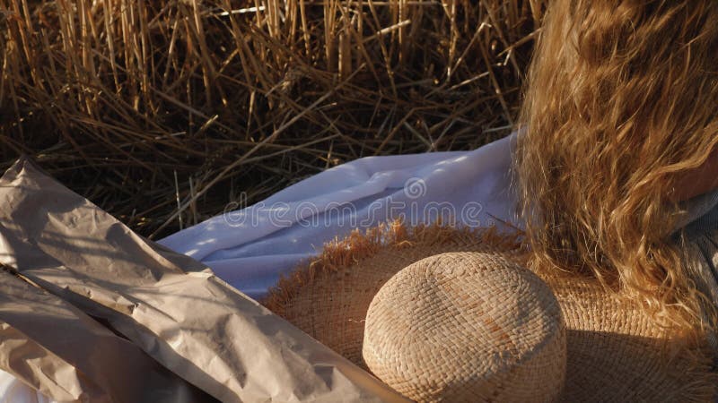 Su una coperta bianca giace pane fresco in una borsa e un cappello e una gomma