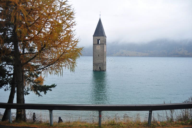 Submerged tower of reschensee church deep in Resias Lake of Bolzano or bozen, Italy