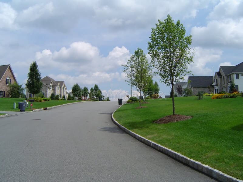 Suburbia. A suburban street and houses Suburbia. A suburban street and houses